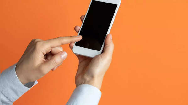 Hand holding phone, index finger scrolling.