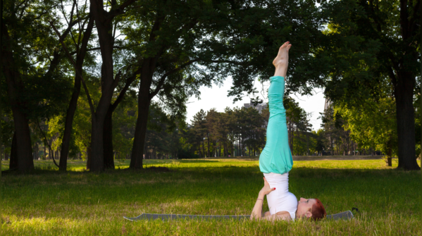 Individual practicing Sarvangasana, or Shoulder Stand.