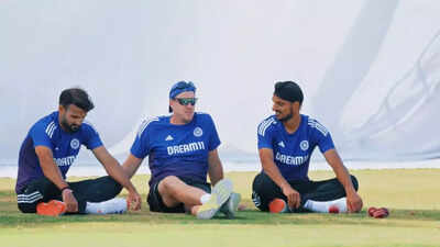 Arshdeep Singh wrestles with coach Morne Morkel during practice.
